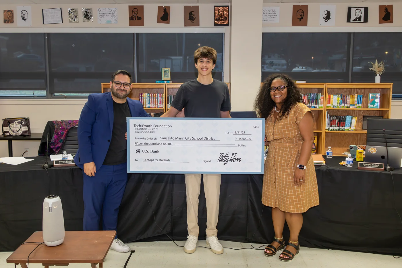 Natty Gove presents a $15,000 check to Sausalito Marin City School District officials